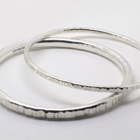 Image shows the Handmade 3mm and 5mm wide Hammered Silver Bangle. This item is the 5mm Bangle