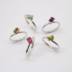 Emerald cut gem stone stacking rings in a variety of colours